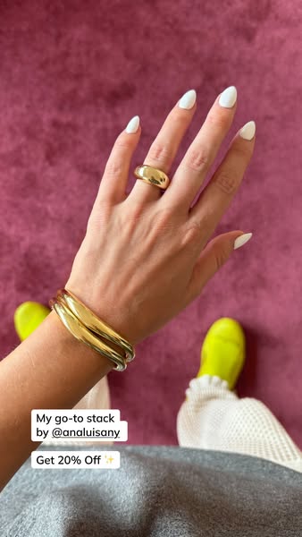 This ad features Ana Luisa jewelry, with a focus on the 'go-to stack' of a gold ring and bangles. The ad is a si