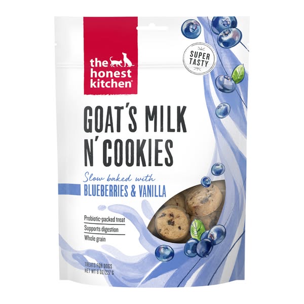 A bag of The Honest Kitchen Goat's Milk N' Cookies dog treats is shown. The bag is white with the brand logo at 