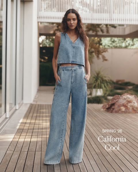 The ad features a woman wearing a matching denim top and wide-leg pants, presenting a casual, California cool style for 