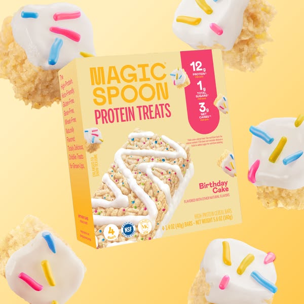 The ad features a box of Magic Spoon Protein Treats in the Birthday Cake flavor. It highlights the product's high pr