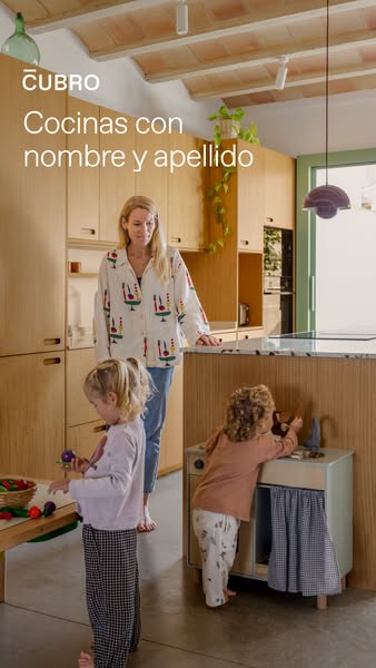 This ad depicts a domestic scene of a mother and her two children in a modern, wooden kitchen. The image is accompanied 
