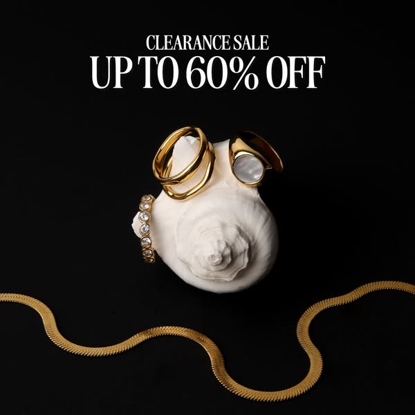 This image ad showcases a selection of gold jewelry, including rings and a necklace, displayed on a seashell against a b