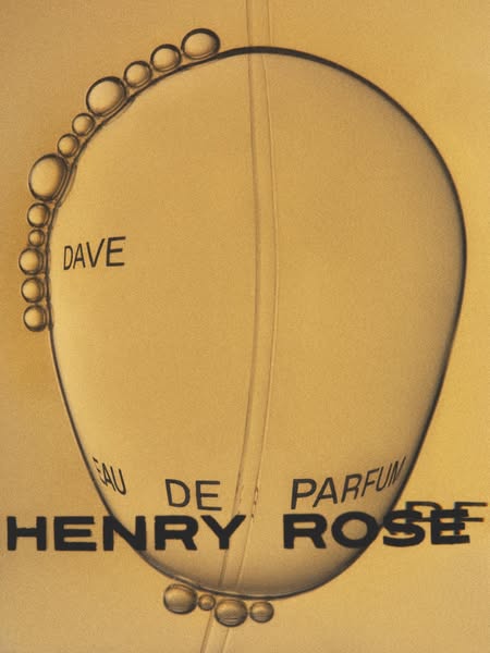 This ad features a macro shot of the Henry Rose perfume bottle, emphasizing its elegant design and the 'Dave' fr