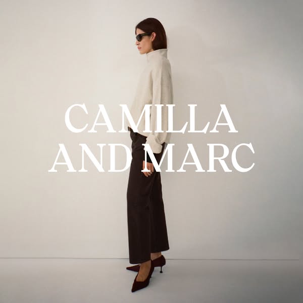 This image ad showcases the brand CAMILLA AND MARC, featuring a model wearing a neutral outfit.
