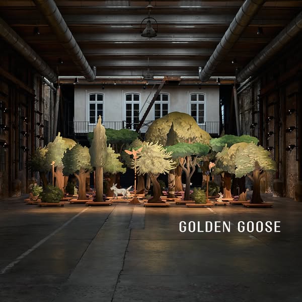 This ad features the brand Golden Goose against a diorama of trees and figurines.