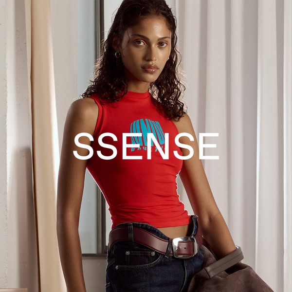 This image ad features a woman wearing a red top with a blue design, jeans, and a belt. The brand "SSENSE" is 