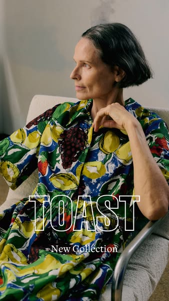 This image ad from Toast features a woman sitting in a chair, wearing a colorful, fruit-patterned shirt from the brand&#