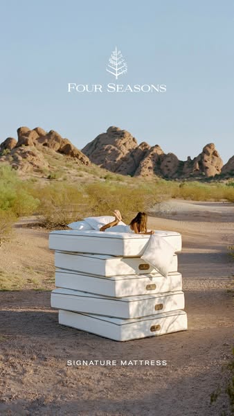 This ad for Four Seasons Signature Mattress features a woman relaxing on a stack of mattresses in a desert landscape, em