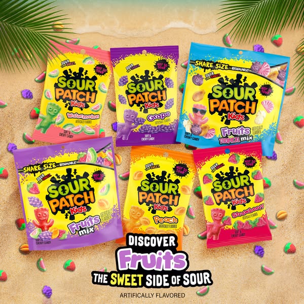 This image ad showcases various flavors of Sour Patch Kids candy in a beach setting, emphasizing the sweet and sour tast