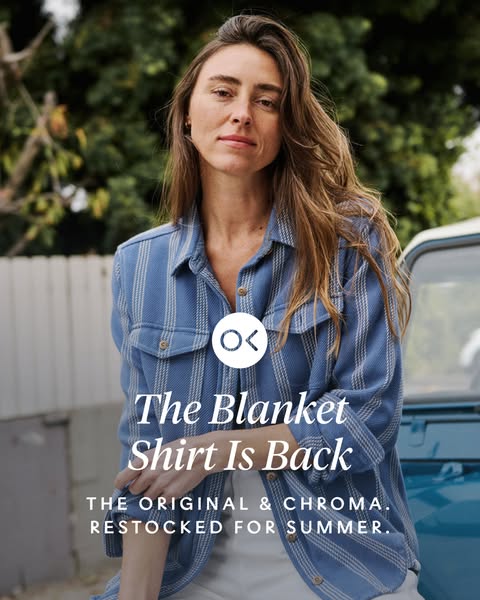 Image ad featuring a woman modeling a blue and white striped shirt with the text overlay 'The Blanket Shirt Is Back.
