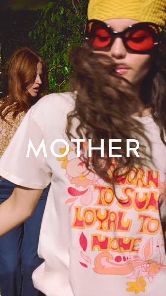 This image ad features two young women, one in the foreground and one in the background, wearing t-shirts from the brand