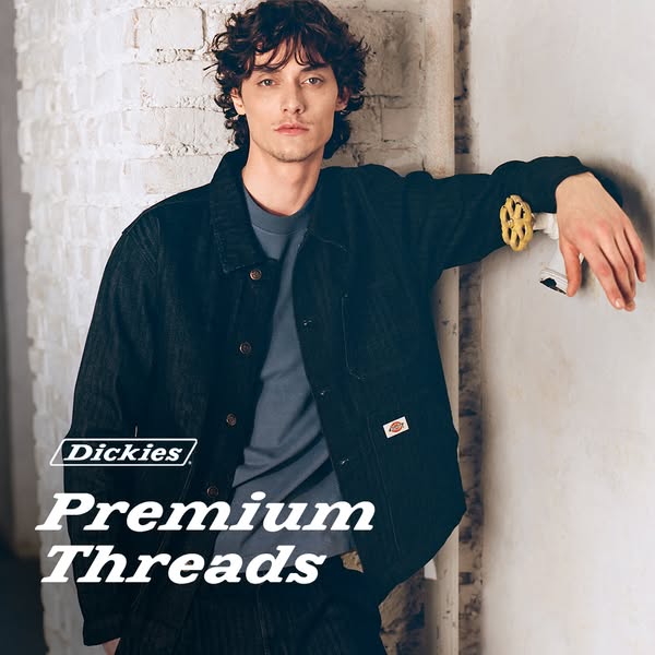 An image ad showcasing clothing from Dickies "Premium Threads". A man with curly hair is leaning against a wal