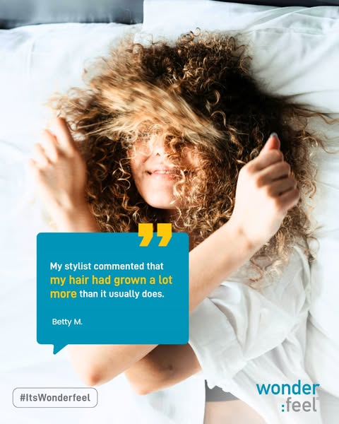 An image ad featuring a woman with curly hair lying in bed on a white pillow, holding her hands in a thumbs-up gesture. 