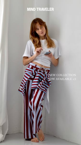 This image ad showcases apparel from Mind Traveler's new collection, featuring a model in striped pants and a matchi