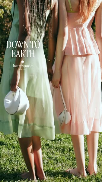 This ad features two women standing in a grassy field, each holding a Kate Spade handbag. The ad promotes a sense of nat