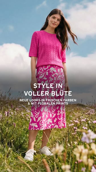 This ad promotes a floral print skirt and coordinated sweater. A woman is seen standing in a field wearing the outfit. T