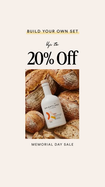 This image ad features a bottle of Brightland olive oil surrounded by bread. The ad promotes a Memorial Day sale where c