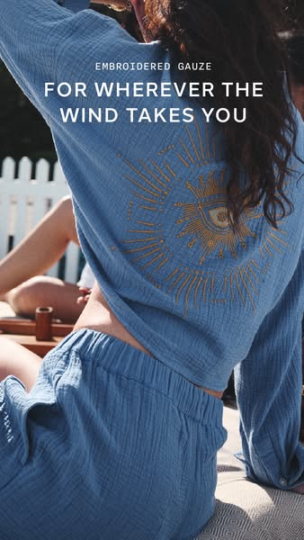 This image ad features a woman wearing a blue embroidered gauze pajama set with the text overlay 'Embroidered Gauze.