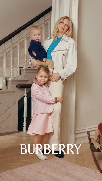 This ad features a photograph of a woman holding a baby with a young girl hugging her leg. The photo is intended to prom