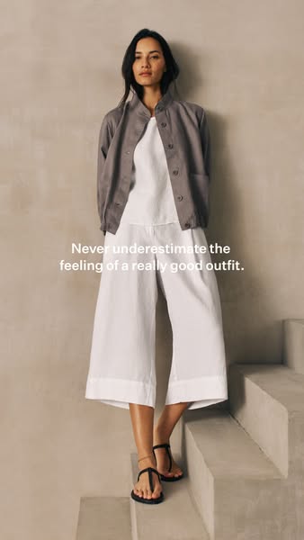 This ad features a woman wearing a linen outfit in a natural, minimalist setting. The headline emphasizes the satisfying