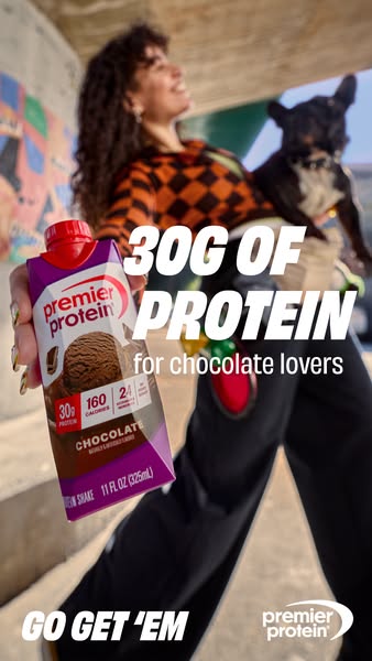 This ad features a woman holding a Premier Protein shake, emphasizing its high protein content and suitability for choco