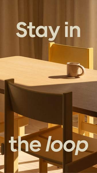 The ad features a beige mug on a wooden table surrounded by chairs. The ad copy says, "Stay in the loop."