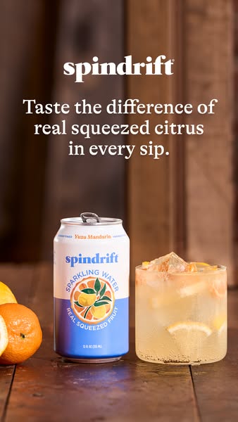 This image ad for Spindrift sparkling water features a can and a glass of Yuzu Mandarin flavored sparkling water, emphas