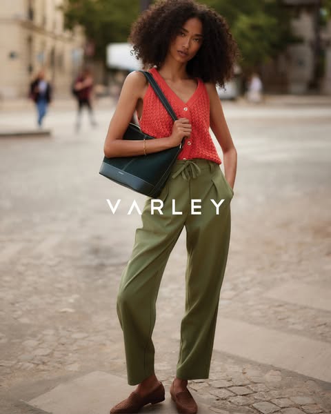 This ad features a woman modeling Varley apparel and a Varley handbag in an urban setting. The ad highlights the brand n