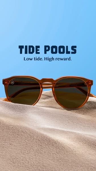 This ad features a pair of orange Knockaround sunglasses positioned on a sand dune. The ad utilizes a visual pun, with t