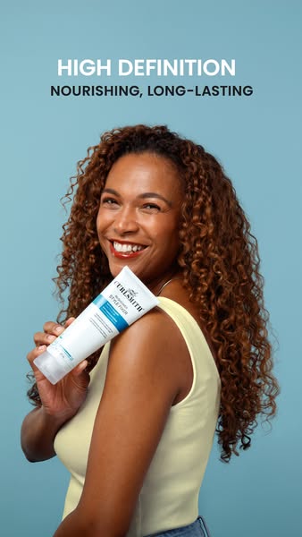 This ad features a woman holding Curlsmith hair product and smiling at the camera. The ad highlights the product's a
