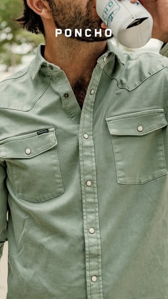 This image ad showcases a man drinking from a water bottle while wearing a button-down shirt from the brand Poncho.
