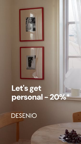 This image ad for Desenio showcases a cozy interior setting with framed pictures on the wall and a discount offer of 20%