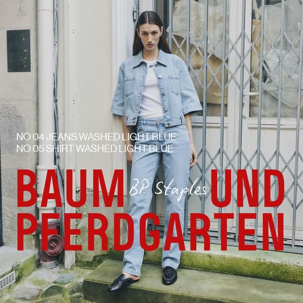 This ad for Baum Und Pferdgarten shows a model wearing the brand's light blue denim shirt and jeans, styled with a w