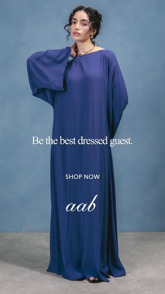 This ad promotes Aab's dresses as suitable for guests. It uses a model wearing a floor-length blue dress against a m