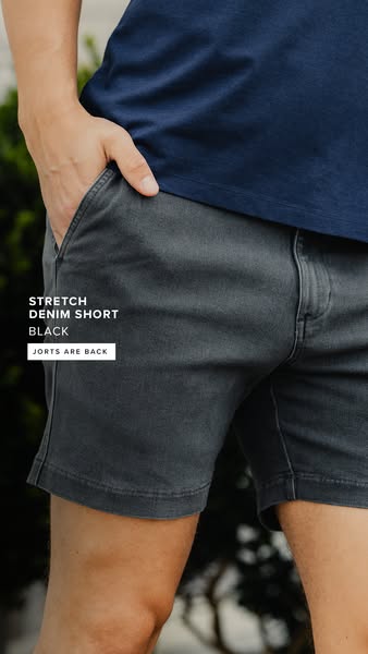 An ad for black denim shorts. The ad is focused on the product.