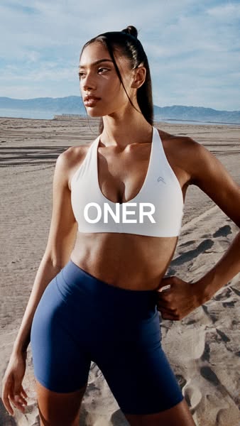 This ad features a woman wearing a white sports bra and blue athletic shorts. The ad promotes the brand Oner.