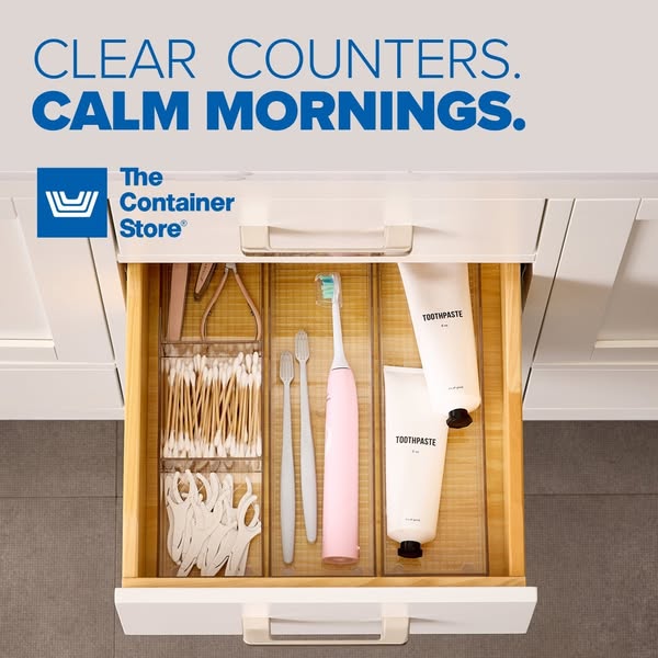 Ad for The Container Store, featuring an organized drawer in a bathroom, created with their organizational products. The