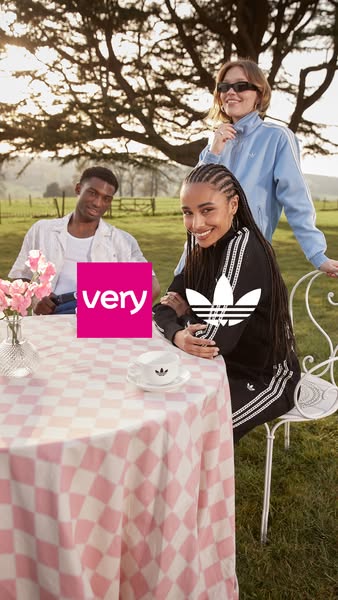 This ad features three models sitting around a table outside. The ad is promoting Adidas apparel, with Very as a retail 
