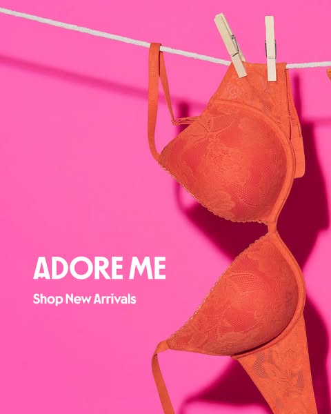 This image ad for Adore Me showcases an orange bra hanging on a clothesline against a bright pink background. The ad pro