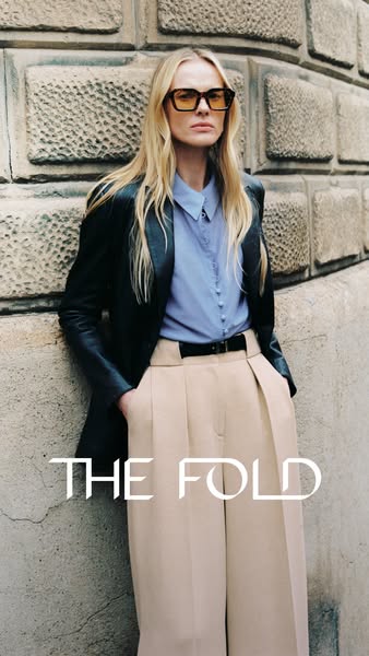 This ad showcases 'THE FOLD' brand and features a woman in a modern, professional outfit.