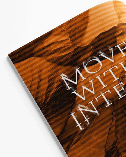 Print ad featuring the text "Move with Intention" overlayed on an image of rock formations.