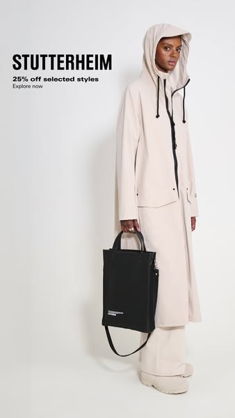 This ad for Stutterheim features a woman in a cream colored hooded rain jacket, matching skirt and shoes. She is holding