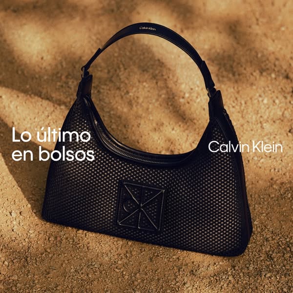 The ad showcases a black Calvin Klein purse on a tan surface.