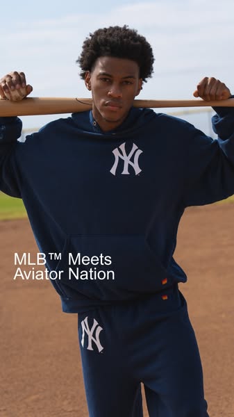 A photo of a person on a baseball field wearing MLB gear from Aviator Nation. The ad highlights the MLB and Aviator Nati