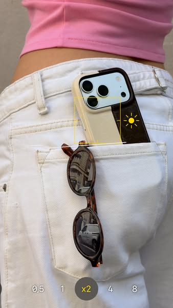 This image shows an iPhone with its camera feature opened. The focal point of the camera is centered on the back pocket 
