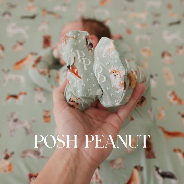 The ad shows a baby wearing clothing with a dog pattern and baby booties being held up by an adult to showcase the style