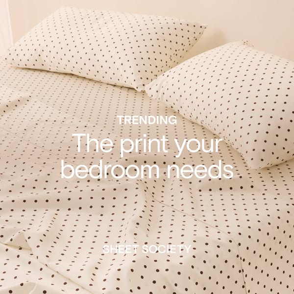 This ad showcases a bedsheet with black polka dots on a light colored background.