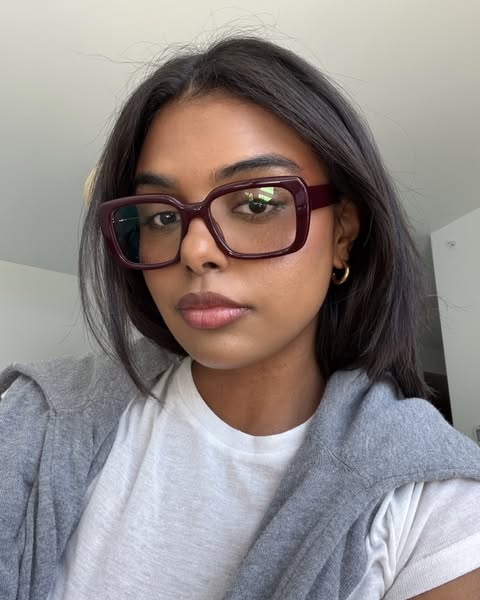 This ad features a portrait of a woman wearing burgundy framed glasses. The ad seems to be targeting people who are look