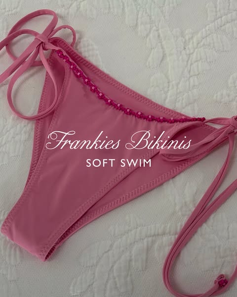 An eye-level shot of a light-pink bikini bottom, designed by Frankie's Bikinis. The shot is close and displays the c