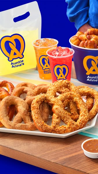 An image ad showing a platter of Auntie Anne's pretzels and drinks with the brand logo prominently displayed on cups